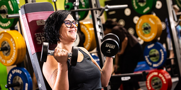Woman doing bicep curls Woman doing bicep curls